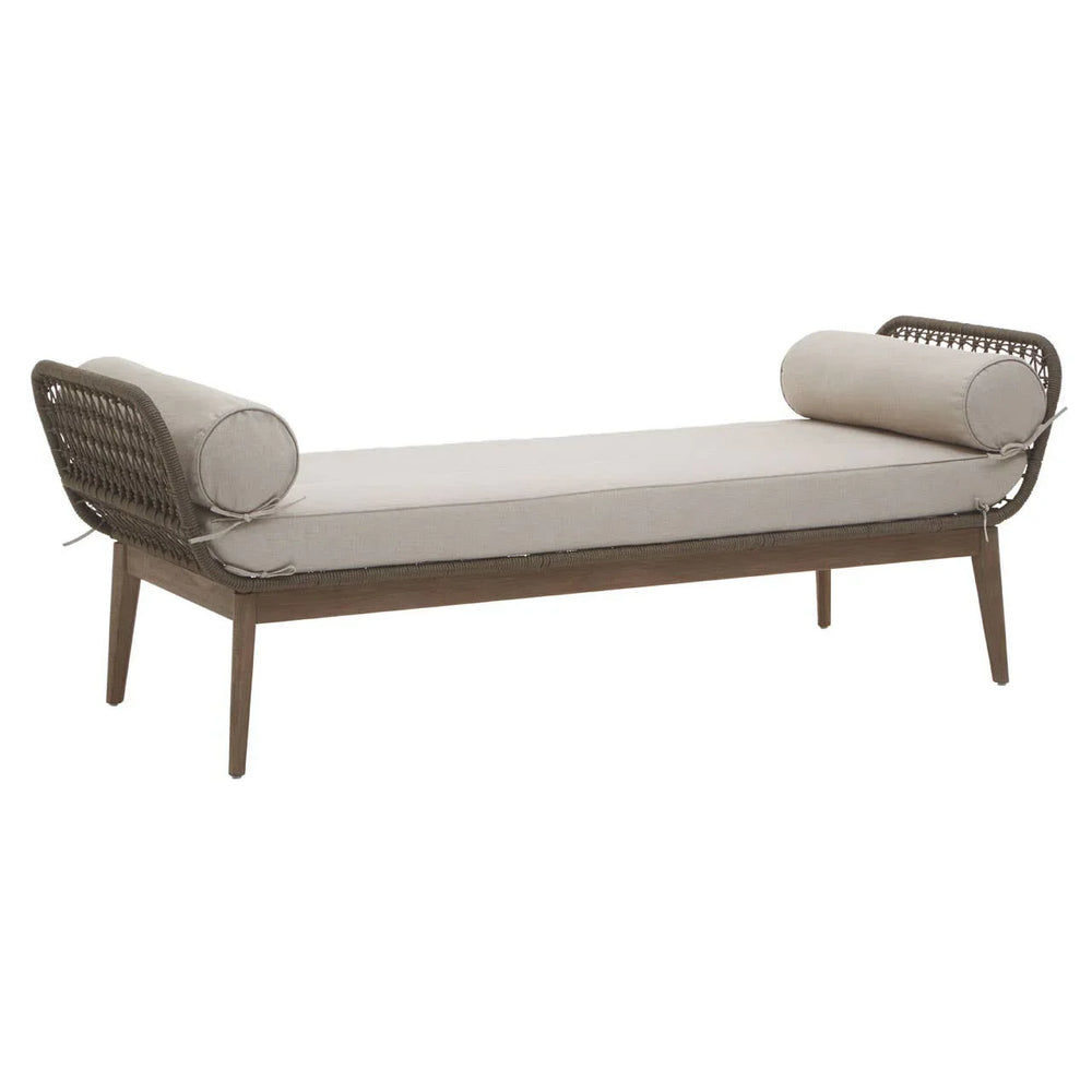 Beige cushioned daybed with wooden frame and round bolster pillows, rattan sides