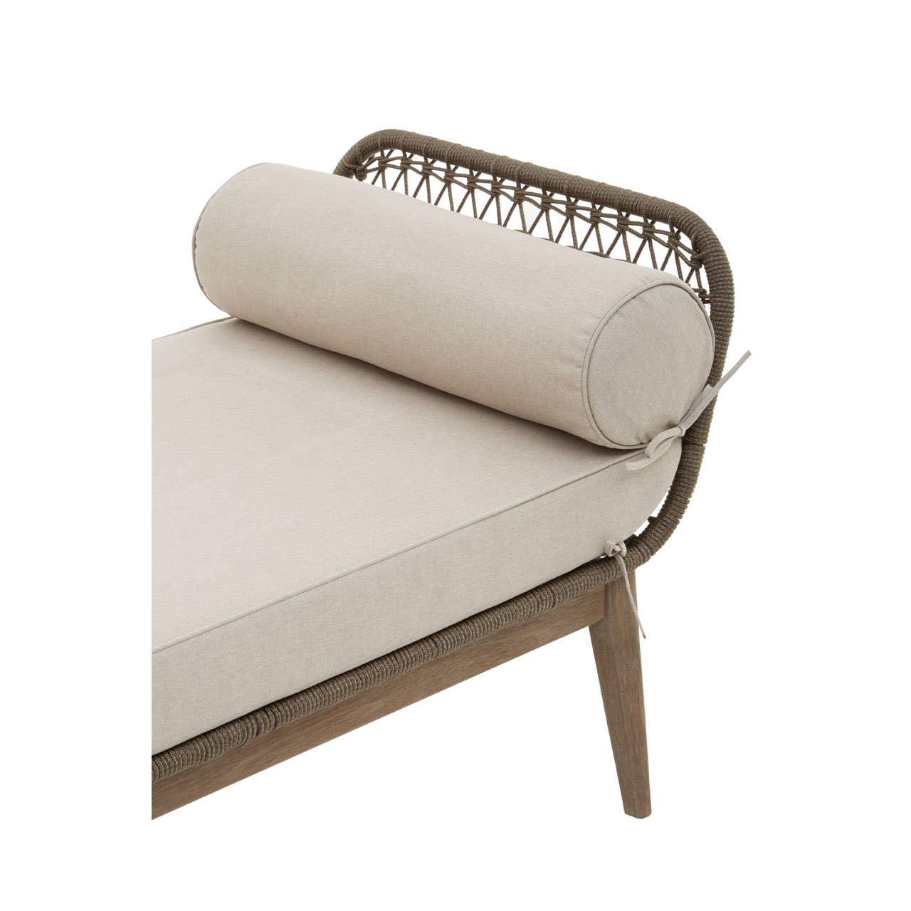 Outdoor daybed with beige cushion, rattan backrest and bolster pillow, angled view