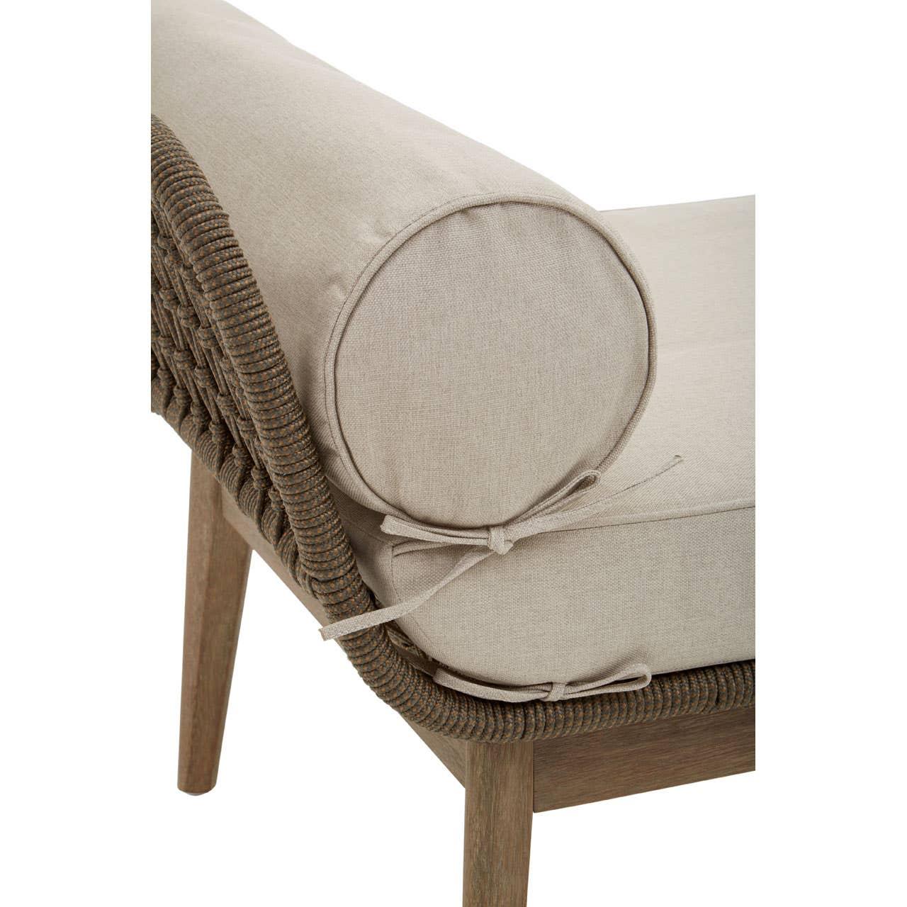 Close-up of beige sofa cushion with round bolster on wooden frame and woven rope side