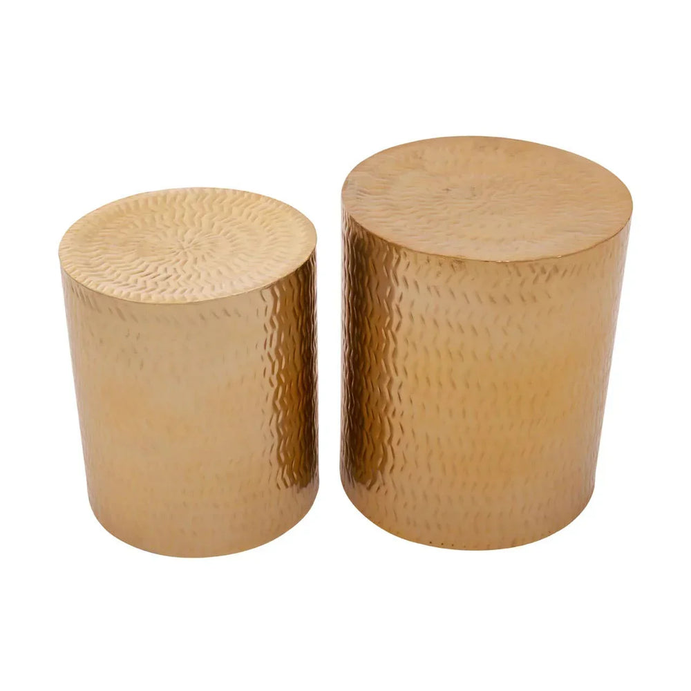 Pair of gold hammered metal side tables with cylindrical shape on white background