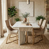 Mink velvet dining chair with a sleek design, positioned around a modern marble dining table in a stylish dining area. The setting features neutral tones, a textured rug, and decorative plants, creating a warm and inviting atmosphere