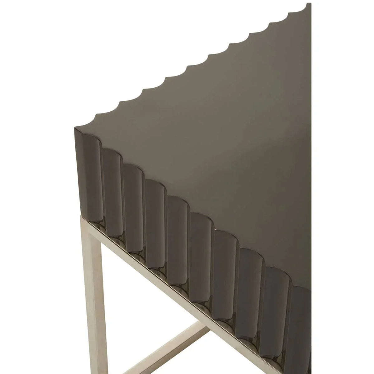 Contemporary side table with scalloped brown tabletop and chrome metal legs, corner view