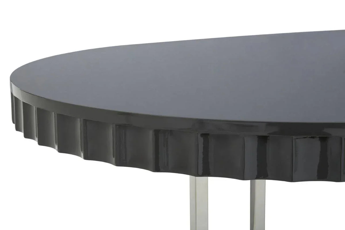 Gloss black dining table with fluted edge detail and chrome legs, close-up view