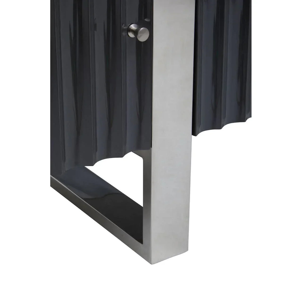Black cabinet with vertical textured doors and brushed metal leg close-up