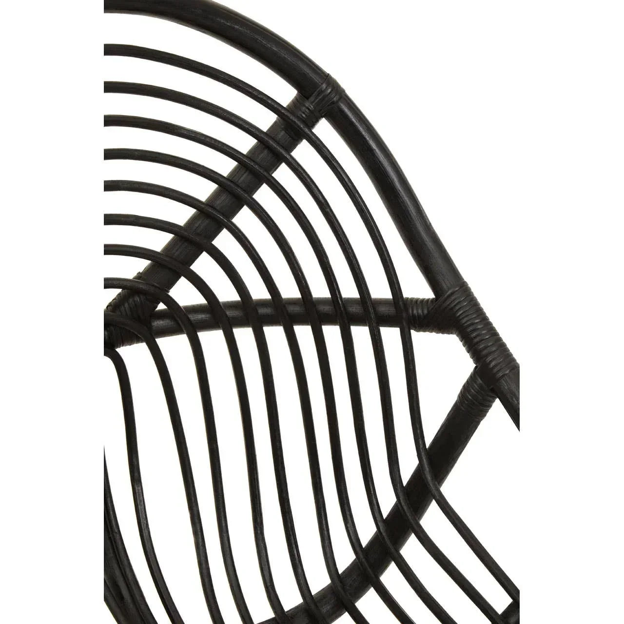 Close-up of black rattan chair backrest showing curved woven pattern