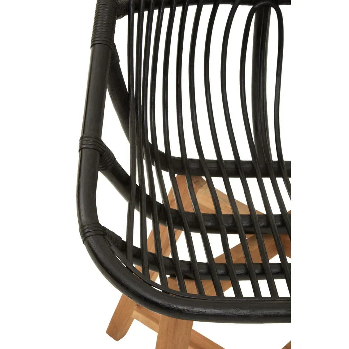 Close-up of black rattan chair seat with natural wood legs