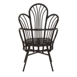 A black metal chair featuring a scalloped back design made from natural rattan, with a round seat and slender legs. The overall structure is elegant and modern, showcasing a combination of materials and a unique silhouette