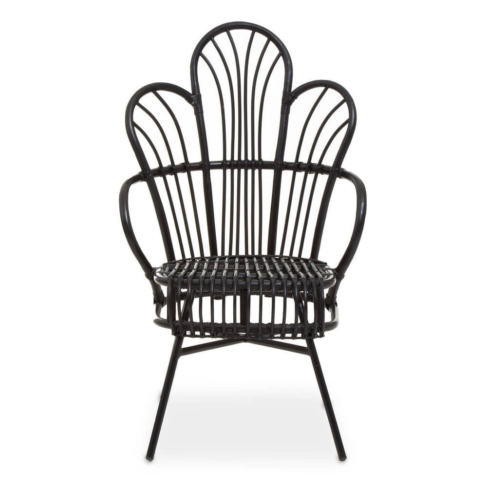 A black metal chair with a scalloped back design, featuring natural rattan accents. The chair has a curved silhouette and slender legs, showcasing a blend of modern and tropical aesthetics. The seat is open and airy, emphasizing the intricate pattern of the backrest