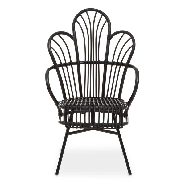 A black metal chair with a scalloped back design, featuring natural rattan accents. The chair has a curved silhouette and slender legs, showcasing a blend of modern and tropical aesthetics. The seat is open and airy, emphasizing the intricate pattern of the backrest