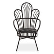 A black metal chair with a scalloped back design, featuring natural rattan accents. The chair has a curved silhouette and slender legs, showcasing a blend of modern and tropical aesthetics. The seat is open and airy, emphasizing the intricate pattern of the backrest