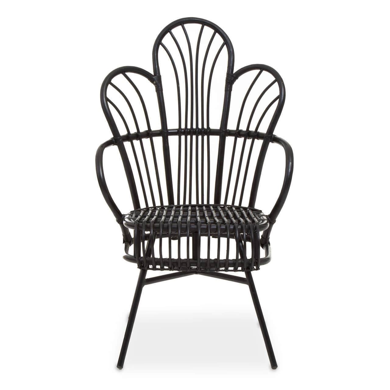 A black metal chair with a scalloped back design, featuring natural rattan accents. The chair has a curved silhouette and slender legs, showcasing a blend of modern and tropical aesthetics. The seat is open and airy, emphasizing the intricate pattern of the backrest