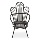 A black metal chair with a scalloped back design, featuring natural rattan accents. The chair has a curved silhouette and slender legs, showcasing a blend of modern and tropical aesthetics. The seat is open and airy, emphasizing the intricate pattern of the backrest