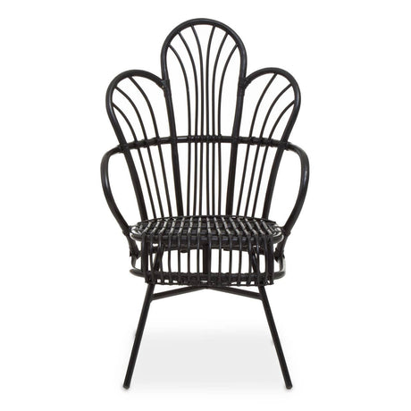 A black metal chair with a scalloped back design, featuring natural rattan accents. The chair has a curved silhouette and slender legs, showcasing a blend of modern and tropical aesthetics. The seat is open and airy, emphasizing the intricate pattern of the backrest