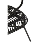 A close-up view of the Java Black Natural Rattan and Black Metal Scalloped Back Chair, showcasing the intricate rattan weaving and the sleek black metal frame. The scalloped back design is visible, highlighting the chair's modern aesthetic. One of the chair's legs is partially visible, emphasizing its sturdy construction
