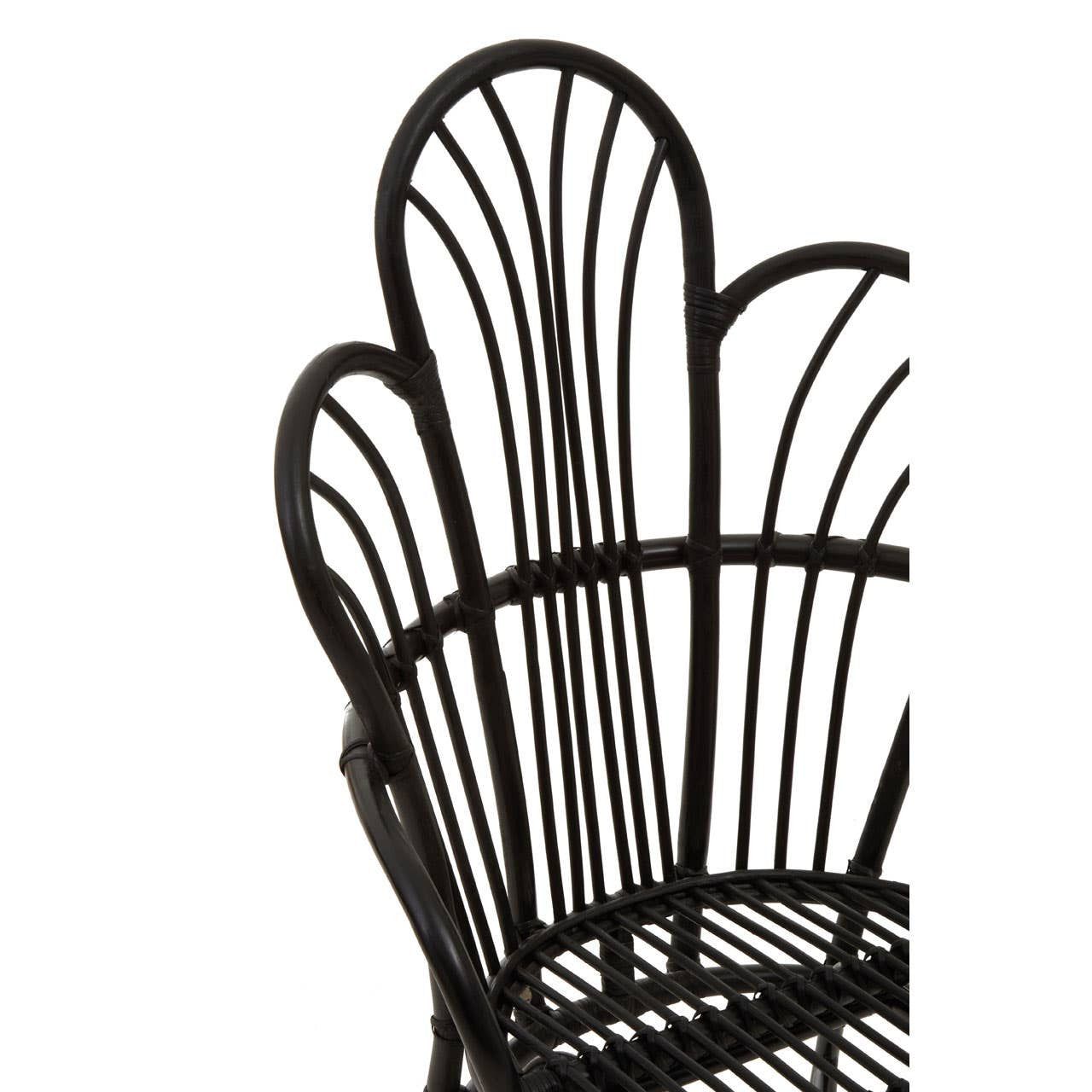 A black metal chair featuring a scalloped back design with natural rattan accents, showcasing a combination of sleek lines and a textured finish. The chair's backrest has a unique, curved shape that adds an elegant touch to its overall aesthetic