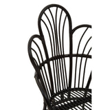A black metal chair featuring a scalloped back design with natural rattan accents, showcasing a combination of sleek lines and a textured finish. The chair's backrest has a unique, curved shape that adds an elegant touch to its overall aesthetic