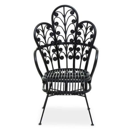 A black rattan chair featuring a scalloped back design with intricate leaf patterns, supported by slender metal legs. The chair has a wide seat and a stylish, open silhouette, suitable for indoor or outdoor use