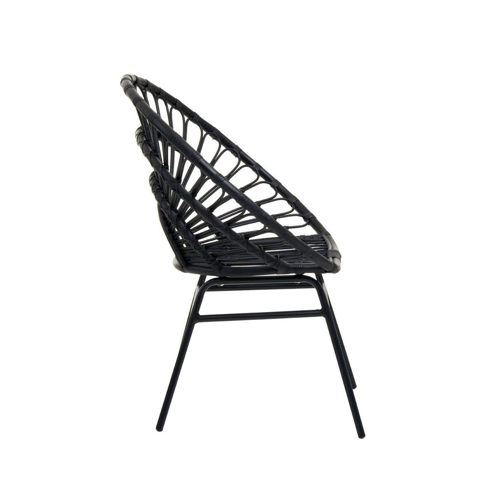 Flared back chair made of black natural rattan, featuring a curved design and slender metal legs, viewed from the side