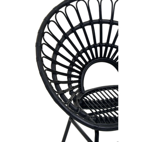 Flared back chair made of black natural rattan, featuring a circular design with vertical spokes and a sturdy base. The chair has a wide, open back and a slatted seat, showcasing a modern and stylish aesthetic suitable for home decor