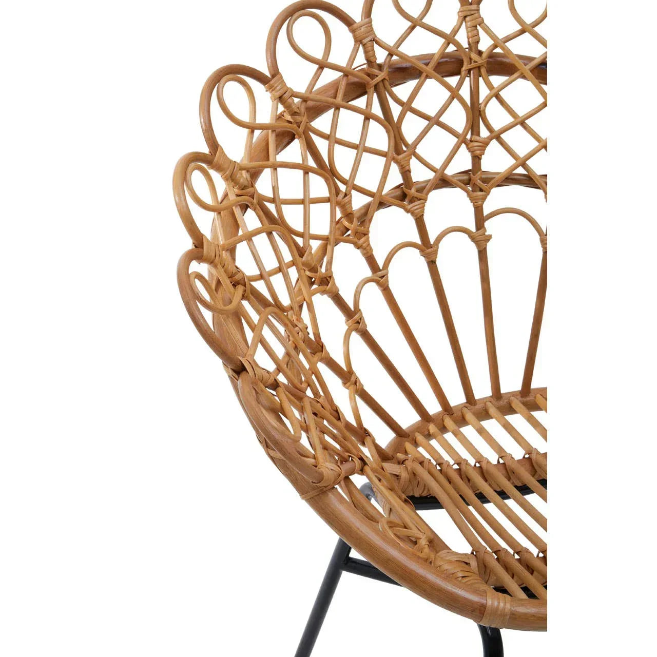 Close-up of woven rattan chair with curved backrest and black metal legs
