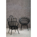 Two black natural rattan peacock chairs are displayed against a textured gray wall, showcasing their unique fan-shaped backs and slender legs. The chairs have a stylish, bohemian design, perfect for adding a touch of elegance to any living space