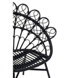 A black natural rattan peacock chair featuring a distinctive fan-shaped backrest with circular patterns, supported by a sturdy frame and a woven seat. The design showcases intricate detailing and a modern aesthetic suitable for home decor