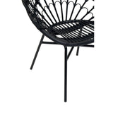 A close-up view of the Java Black Natural Rattan Peacock Chair, showcasing its intricate rattan weaving and sleek black metal legs. The chair features a rounded back with a fan-like design, emphasizing its bohemian style and elegant curves