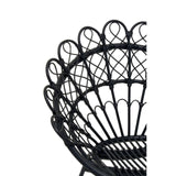 A close-up view of the Java Black Natural Rattan Peacock Chair, showcasing its intricate woven design and curved backrest with a fan-like shape. The chair features a sturdy circular base and elegant detailing in the rattan material, emphasizing its stylish and bohemian aesthetic