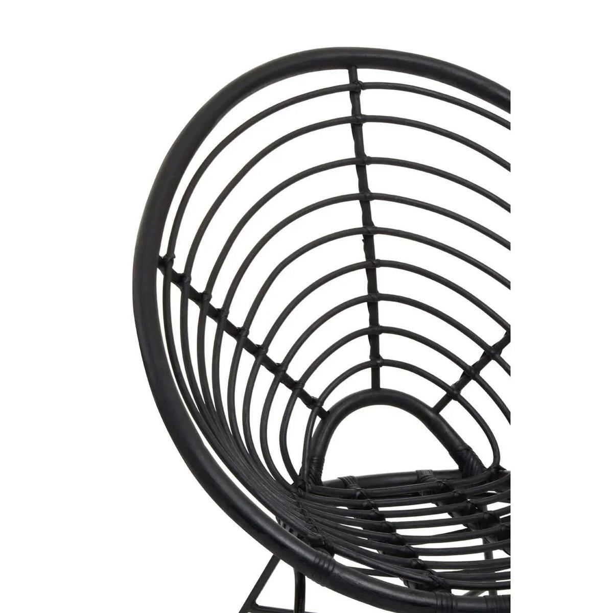 Black rattan chair with curved open weave design, close-up view of the backrest