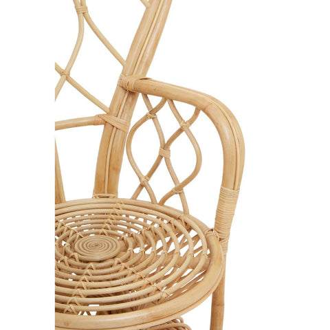 Curved chair made from natural rattan featuring a woven seat and backrest with a decorative lattice design, showcasing a light, airy aesthetic suitable for home decor