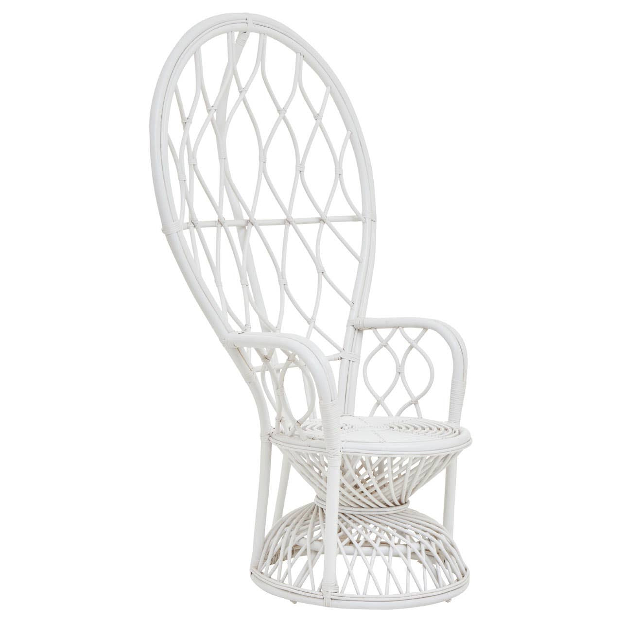 Curved chair made of natural rattan in a grey and white color scheme, featuring an intricate woven design and a comfortable seat cushion. The chair has a tall backrest and a round base, showcasing a modern and stylish aesthetic suitable for home decor