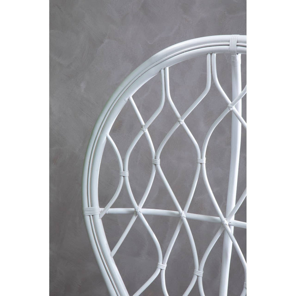 Curved chair made of natural rattan, featuring a grey and white color scheme with a geometric woven pattern. The background is a textured grey surface, highlighting the chair's design