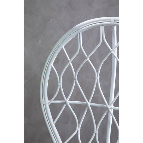 Curved chair made of natural rattan, featuring a grey and white color scheme with a geometric woven pattern. The background is a textured grey surface, highlighting the chair's design