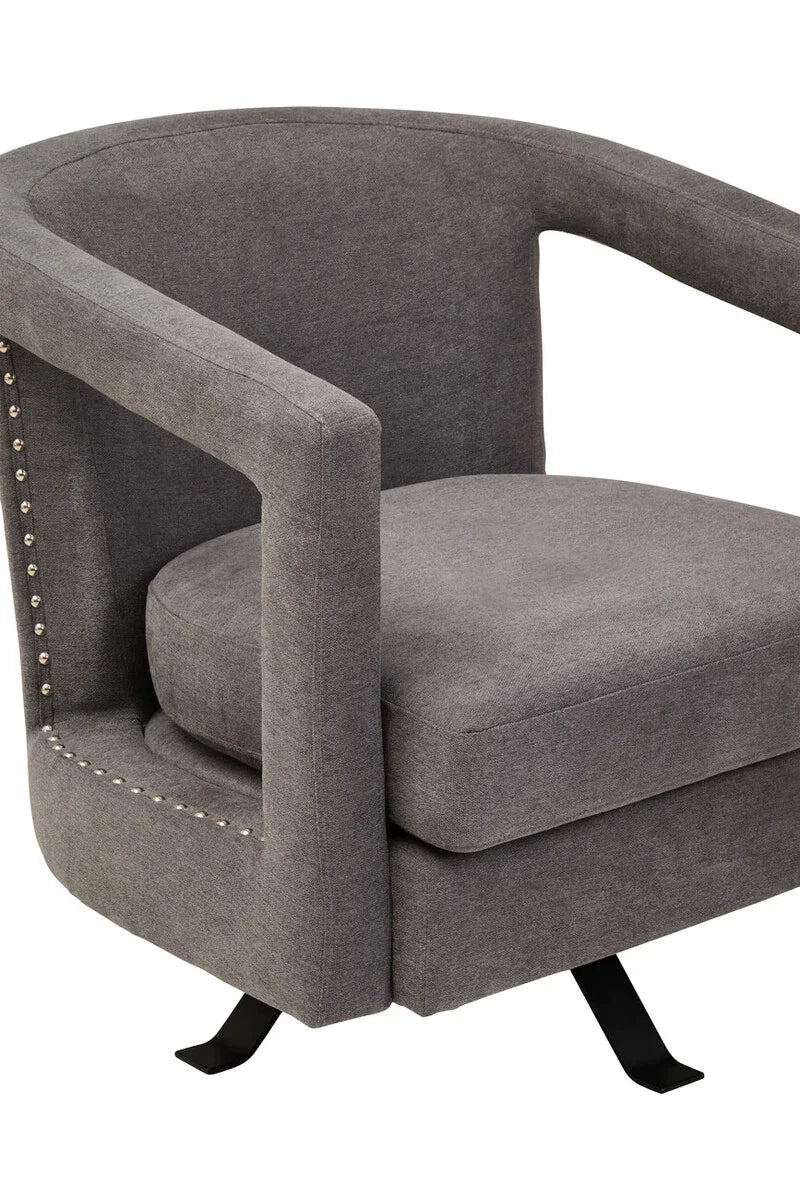 Grey fabric accent chair with curved back, metal legs and studded armrest detailing