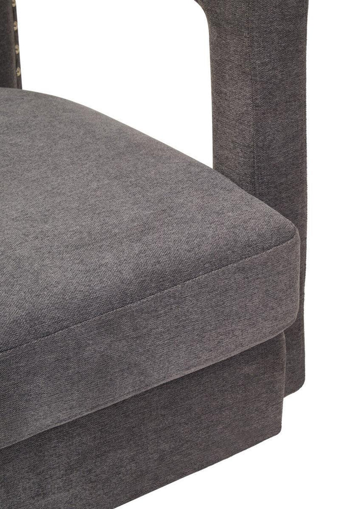 Closeup of grey fabric upholstered sofa seat cushion and armrest