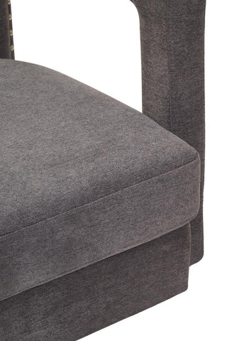Closeup of grey fabric upholstered sofa seat cushion and armrest