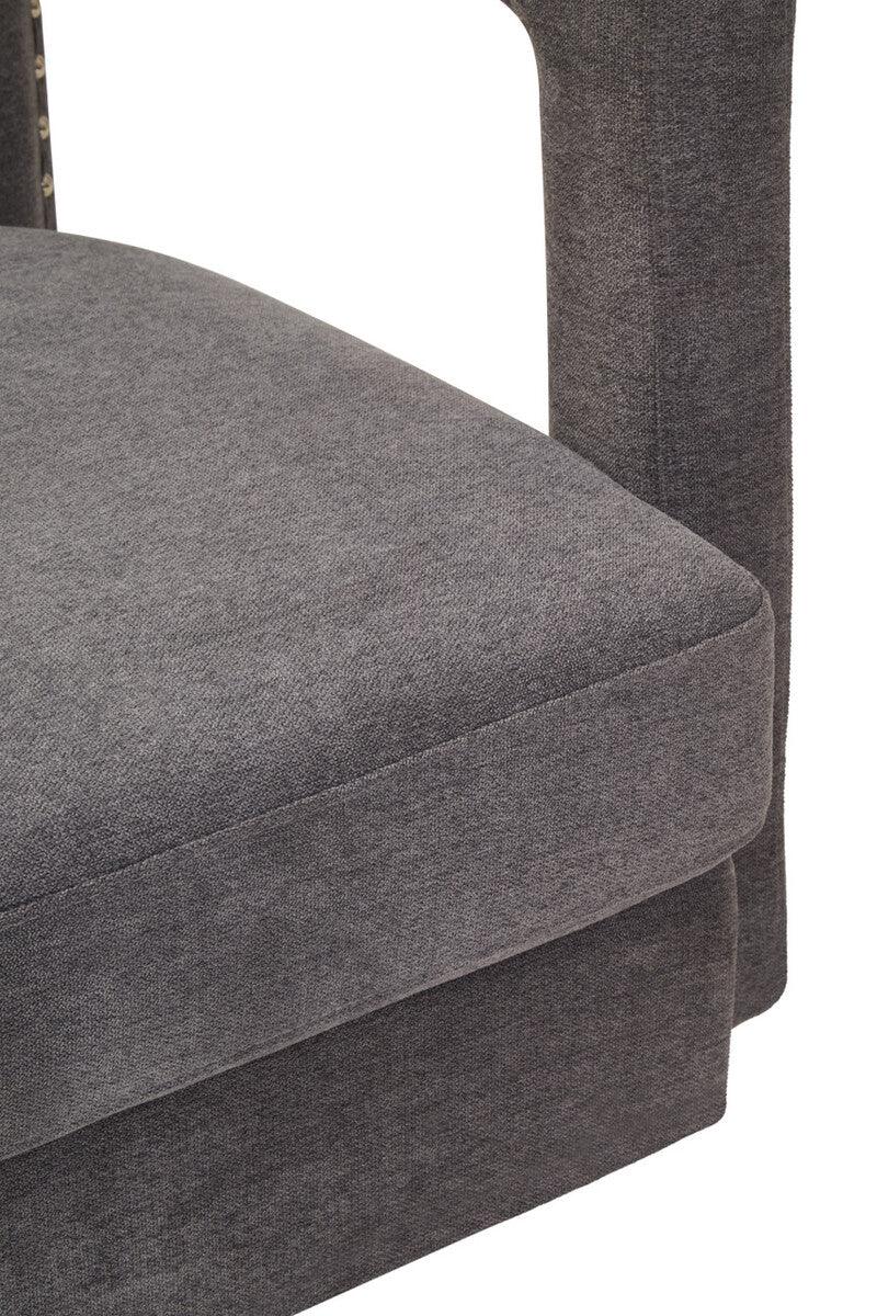 Closeup of grey fabric upholstered sofa seat cushion and armrest