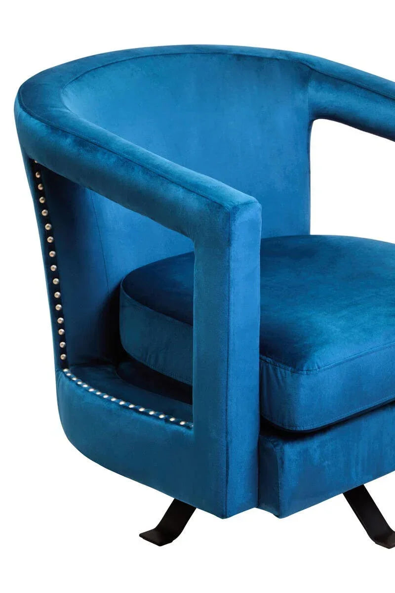 Blue velvet accent chair with curved back, silver stud trim, and black metal legs