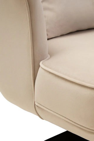 Close-up of beige fabric sofa armrest and cushion detail