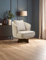 Beige fabric accent chair with cushion on wooden floor in modern living room setting