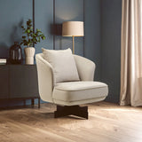 Cream accent chair with cushion and black base in modern living room on wood flooring