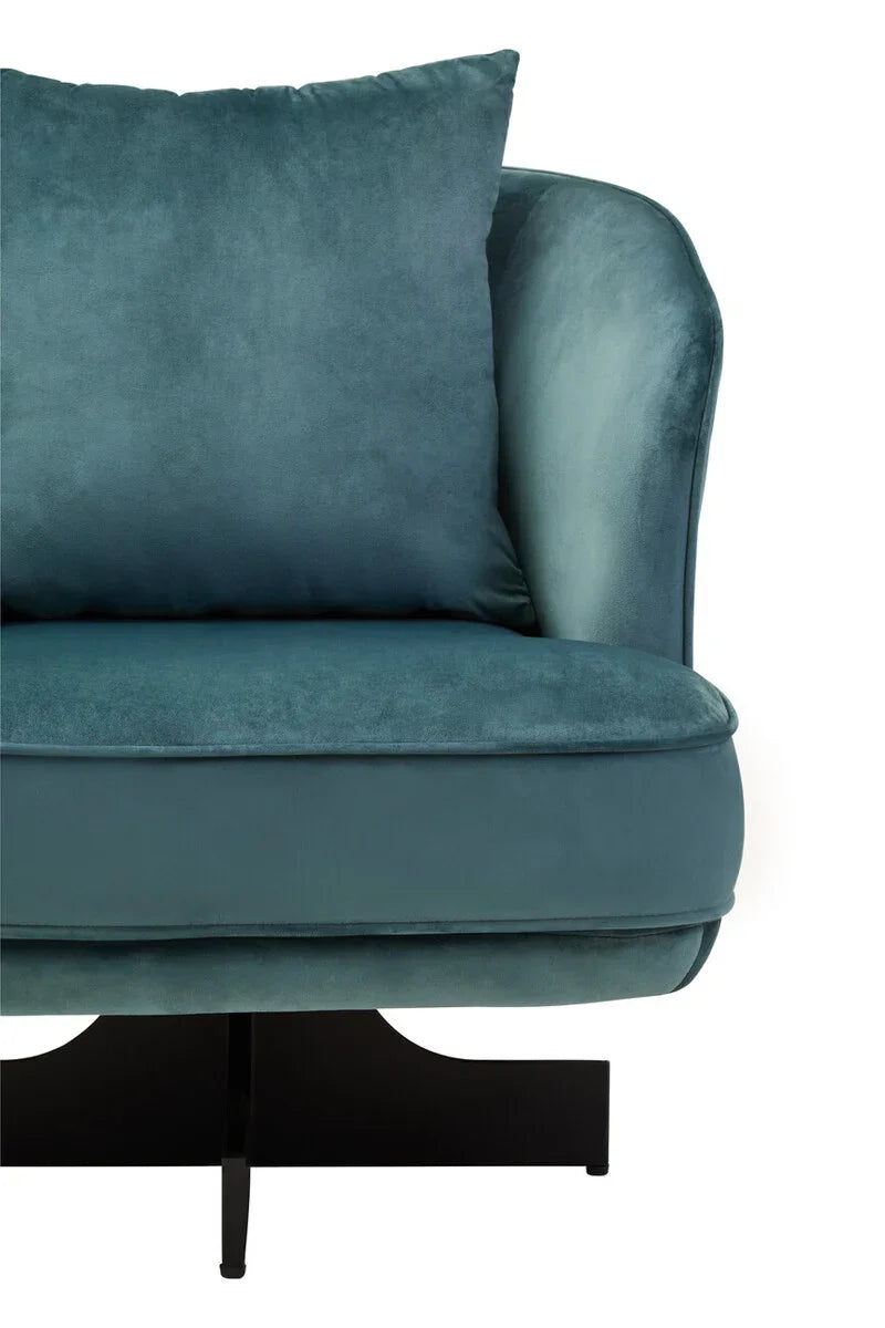 Teal velvet armchair with cushion and black metal legs, close-up on seat and backrest