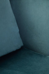 Closeup of teal velvet sofa seat with matching backrest cushion