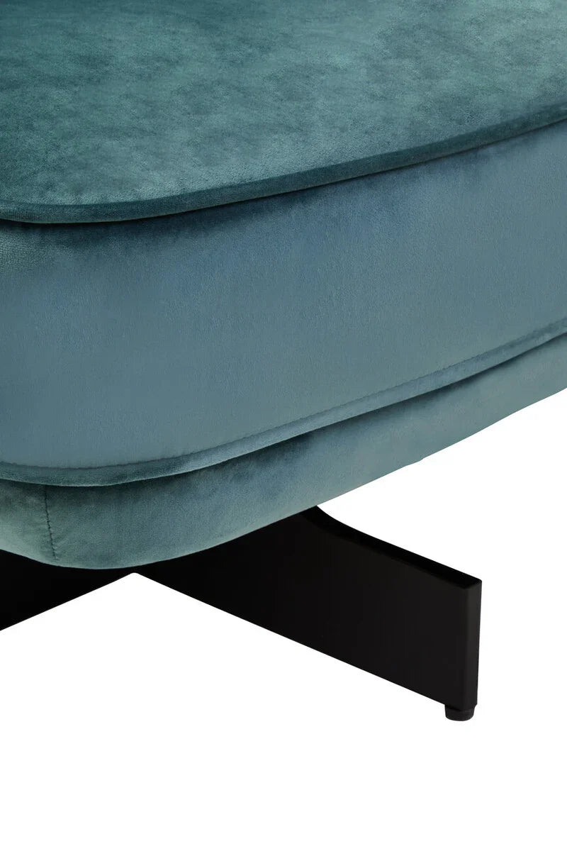 Close-up of teal velvet sofa cushion with black metal base detail