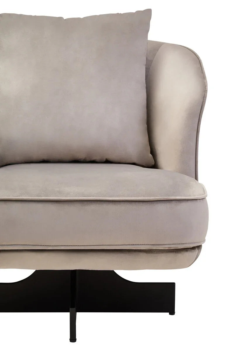 Close-up of grey velvet sofa seat with cushion and modern black base