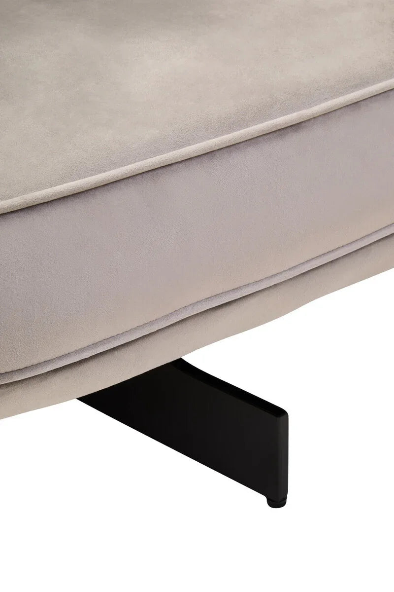 Close view of beige fabric sofa seat cushion with black metal leg support