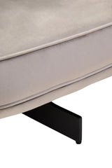 Close view of beige fabric sofa seat cushion with black metal leg support