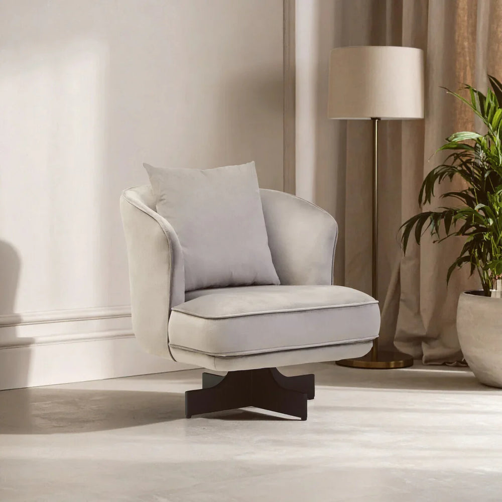 Beige swivel accent chair with cushion and dark wood base in living room setting