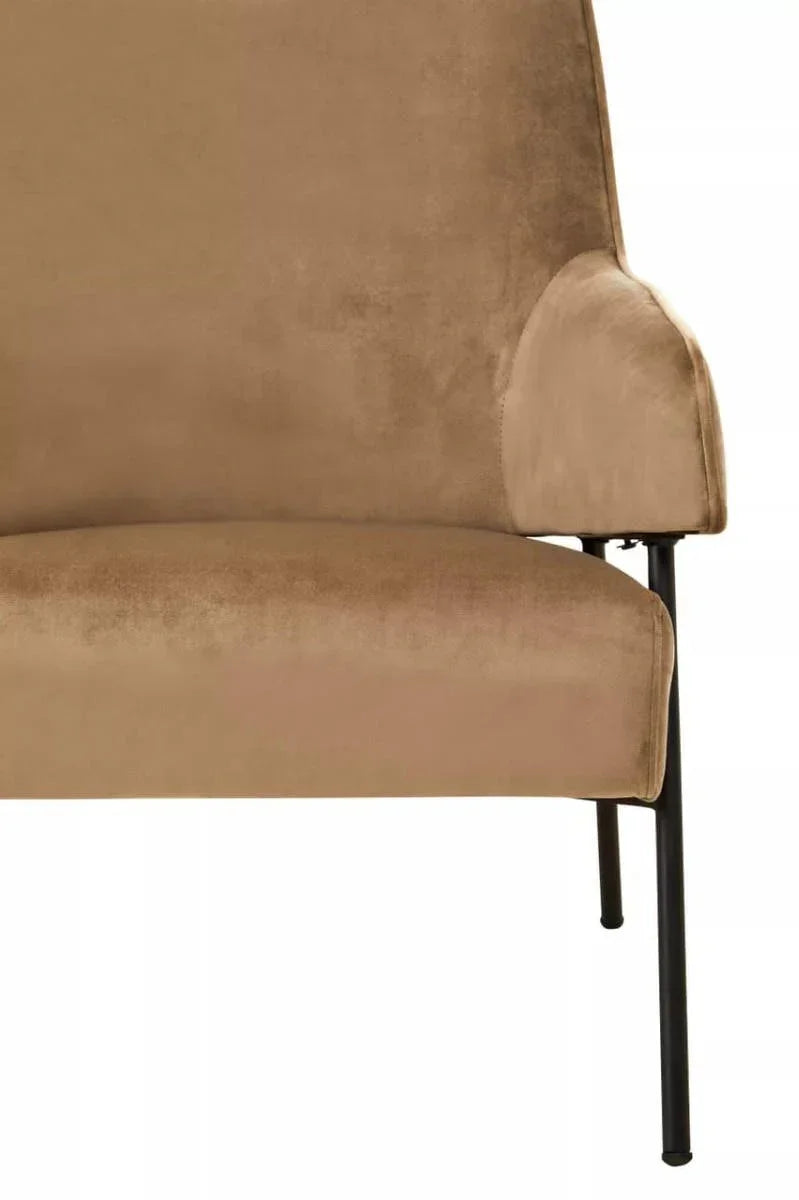 Tan velvet accent chair with black metal leg, close up of arm and seat