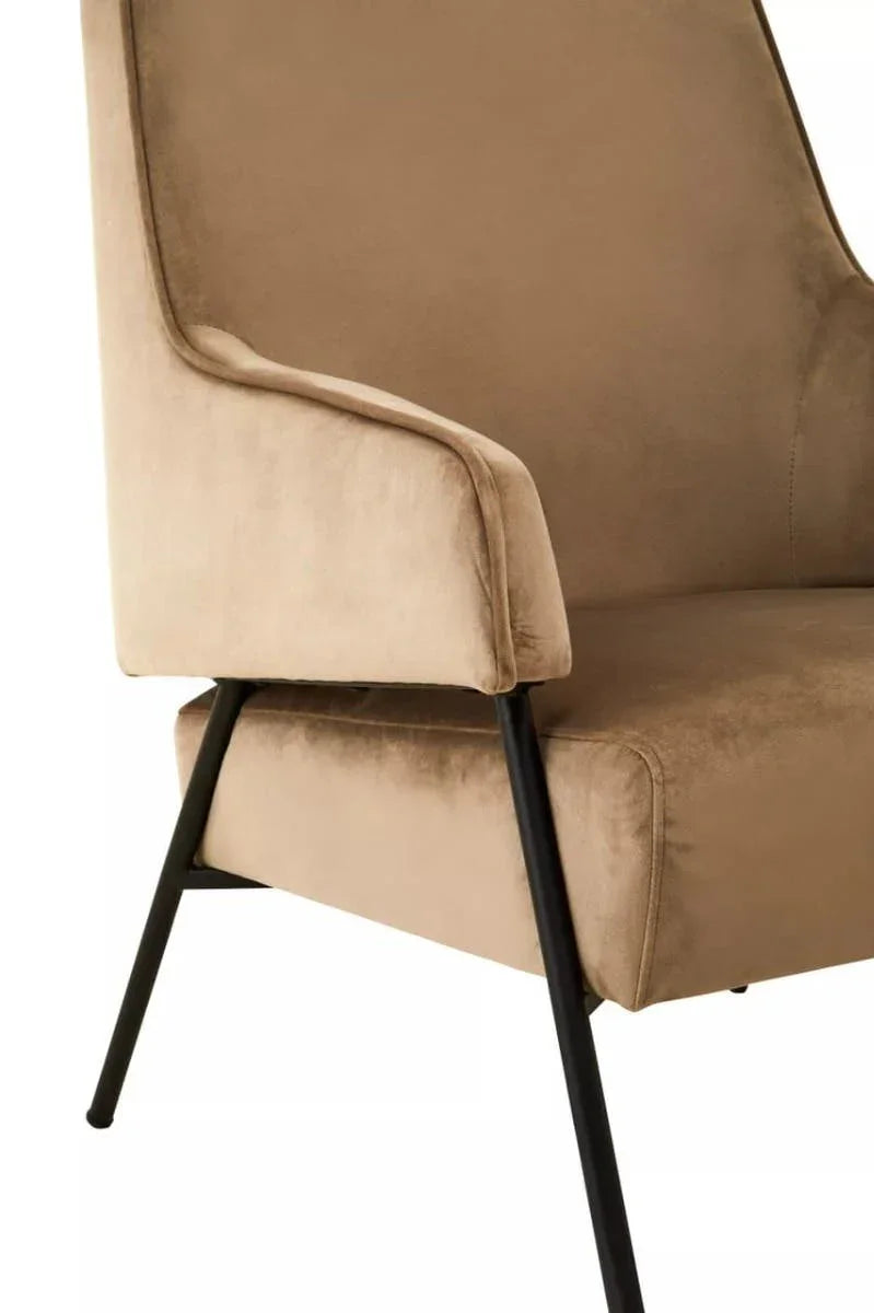 Beige velvet dining chair with black metal legs, close-up of armrest and seat detail